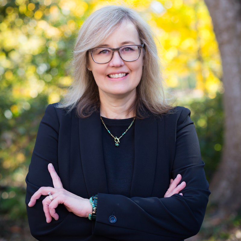 Certified Child Welfare Specialist Attorney Angie Stephenson poses for a photo in a park in Chapel Hill