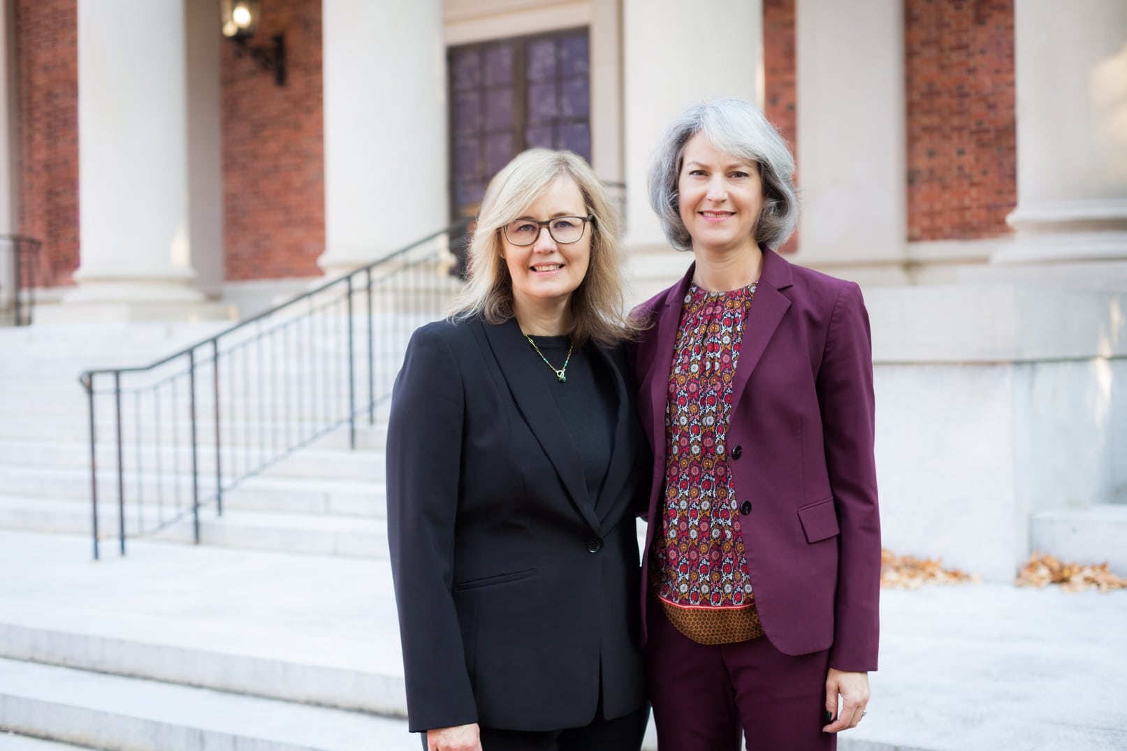 Two strong female attorneys stand together for a photo near the Orange County, NC courthouse.