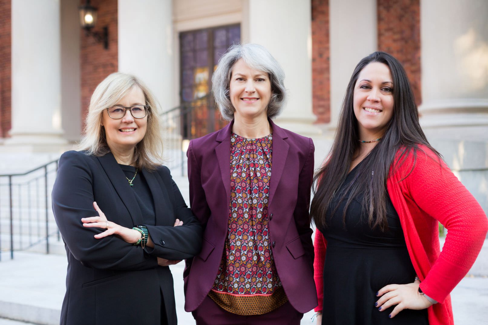 The staff of the Stephenson & Fleming law firm pose for a photo in front of the Old Well at UNC.