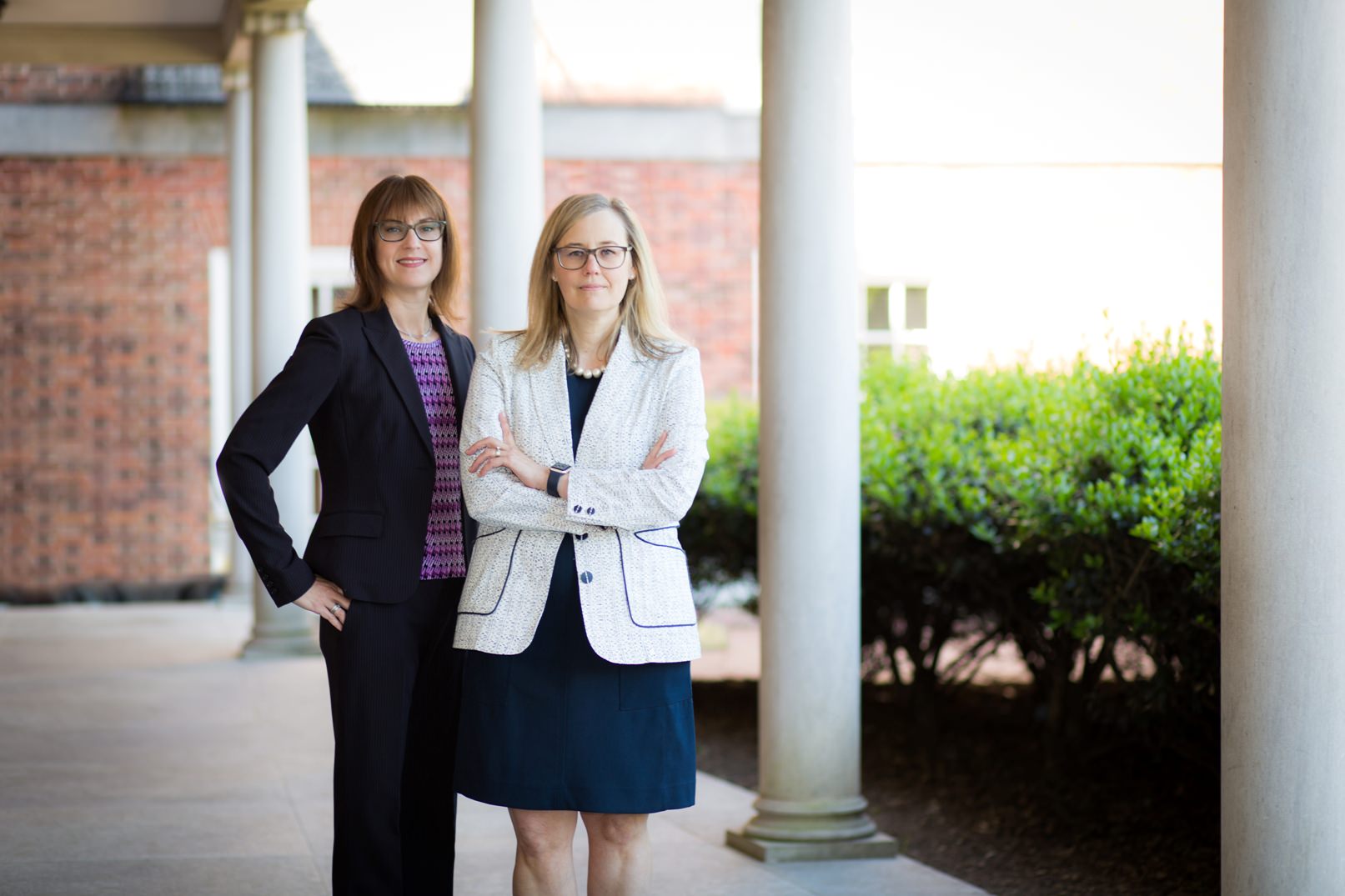 Two strong female attorneys stand together for a photo near the Orange County, NC courthouse.